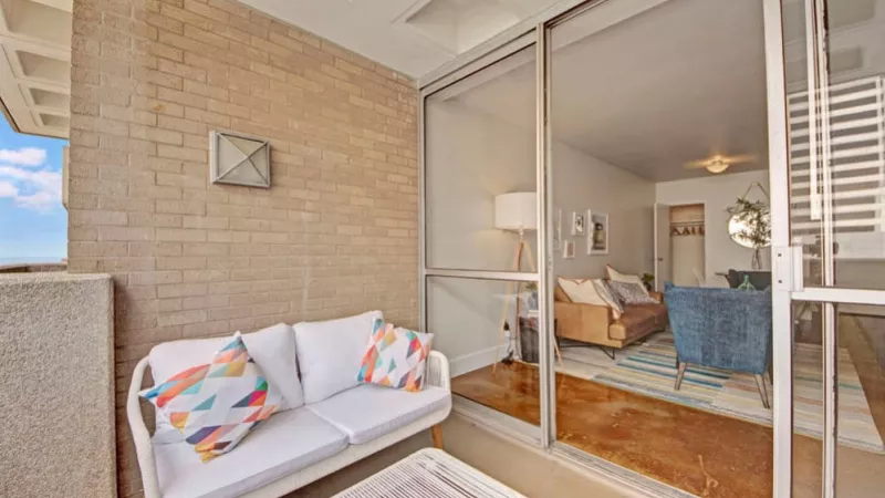 An inviting outdoor seating area connected to the living space through glass doors.